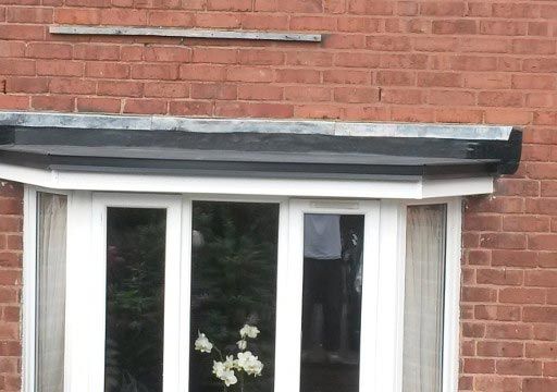 A rubber roof installed above a bay window